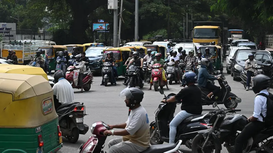 Commuters wait through multiple signal cycles at junctions along Old Madras Road